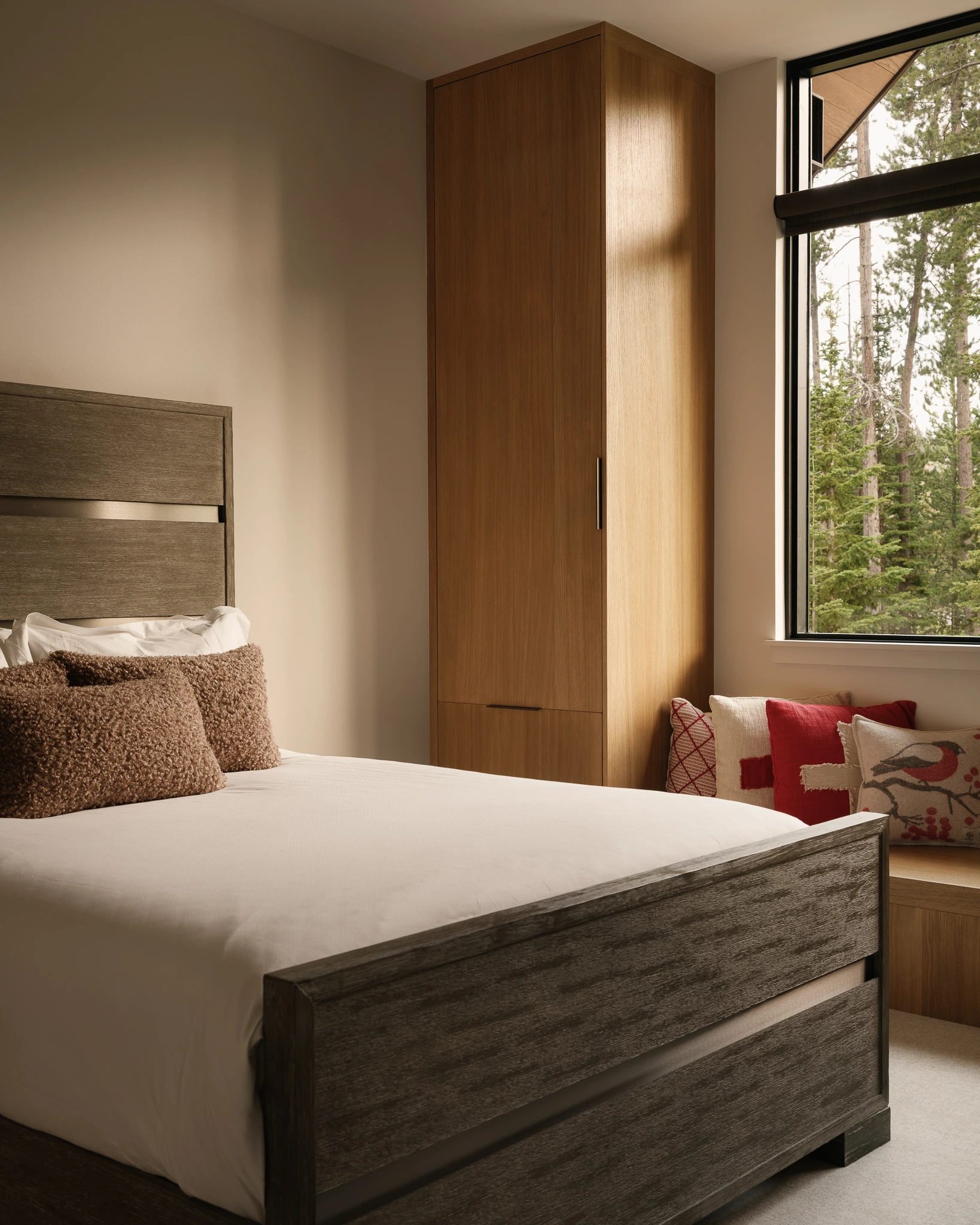 Guest bedroom with built-in wardrobe and window seat — interior design photography Big Sky Montana, Speedwell Cabin
